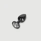 Anal Collection: kleine metalen buttplug met rond sieraad - zwart/transparant